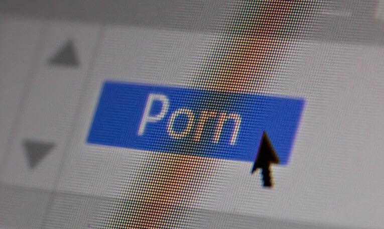 Porn text and sex content concept on computer screen. Closeup screenshot, screen pixels and cursor pointer