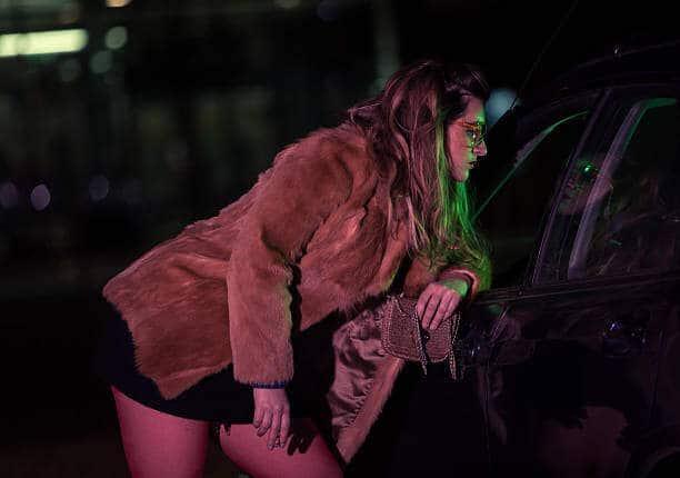Prostitute by the car by night